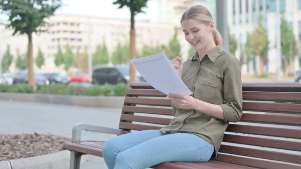 Young Woman Enjoying Success While Reading Documents Outdoor — ストック写真