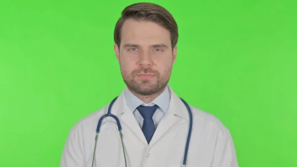 Serious Young Adult Doctor Green Background — Fotografia de Stock