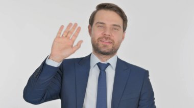 Young Adult Businessman Waving Hand to Say Hello on White Background