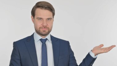 Young Adult Businessman Pointing on Side on White Background