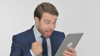 Young Adult Businessman Celebrating Success on Tablet on White Background
