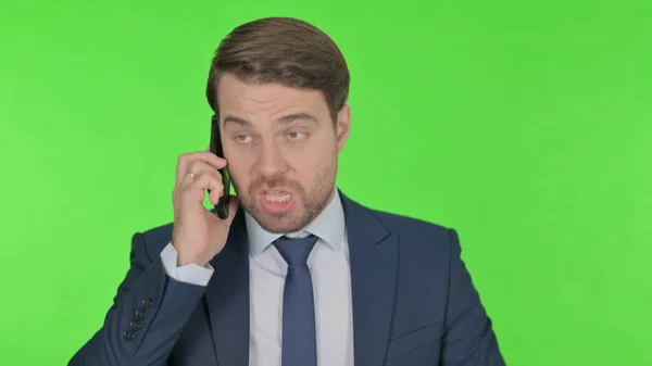 Young Adult Businessman Talking Angry Phone Green Background — стоковое фото