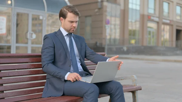 Young Businessman Leaving Bench Closing Laptop — стоковое фото