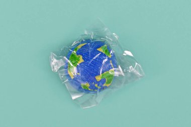 Planet earth model wrapped in plastic