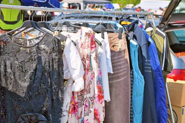 Heidelberg, Germany - August 2022: Rack with old second hand clothes at flea market