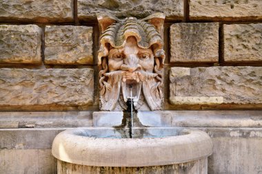 Mannheim, Germany - September 2022: Water spitting gargoyle head at Water Tour called 'Wasserturm' 