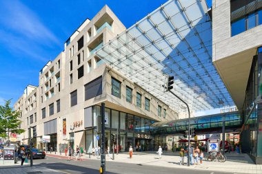 Mannheim, Germany - September 2022: Entrance of big modern shopping center called 'Q6 Q7' with people in city center