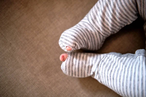 Baby clothes with a hole in the foot — Stock Photo, Image