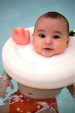 Bebek jakuzide eğleniyor. Bebekler için spa. Çocuklar için hidroterapi seansı. Bebek yüzme