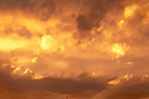 Sunset or dawn sky, yellow clouds with rays and hidden sun. Heaven high/ Copy space
