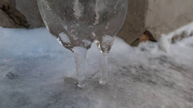 Original winter icicle on the wall of the house