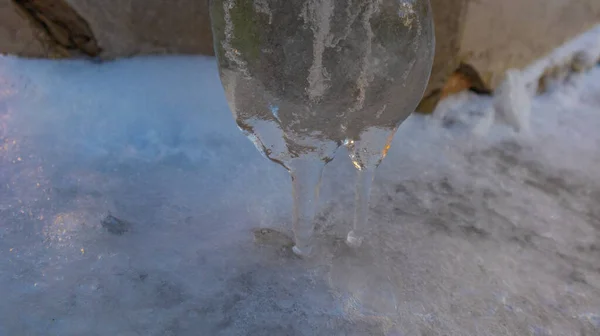 Original winter icicle in the form of a human figure on the wall of the houseriginal winter icicle on the wall of the house. High quality photo — Zdjęcie stockowe