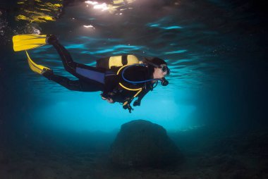 Diver exploring an underwater cavern in the Mediterranean