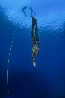 Freediver training with a line in the open sea