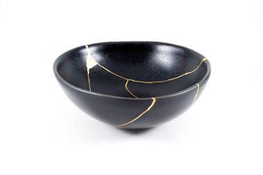 Gold cracks Kintsugi, broken black repaired bowl, Japanese technique. clipart