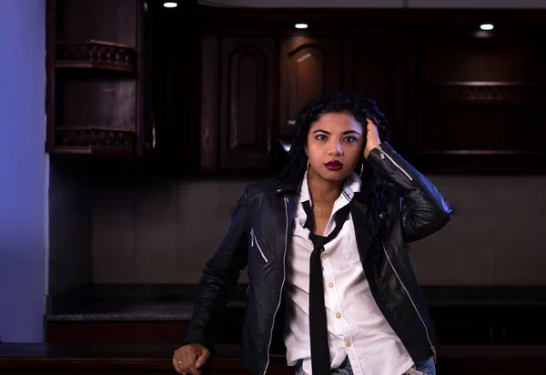 Empowered African American Woman with a lot of style in black letter jacket
