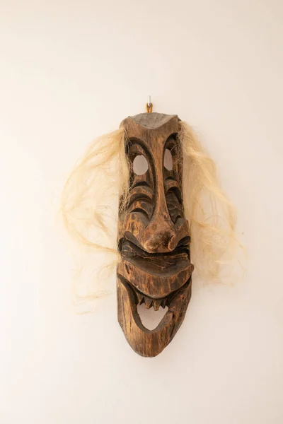 Wood face mask with hair, decoration on the wall