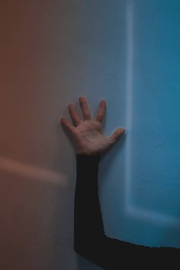 Female hand on the wall, lines geometry, form, colors