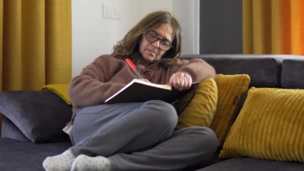 Middle Aged Woman Writing Her Notepad Relaxed Sofa Concept Tranquility — Stockvideo