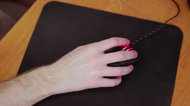 Young male gamer hand on computer mouse moving in slow motion on black mouse pad — Stock Video