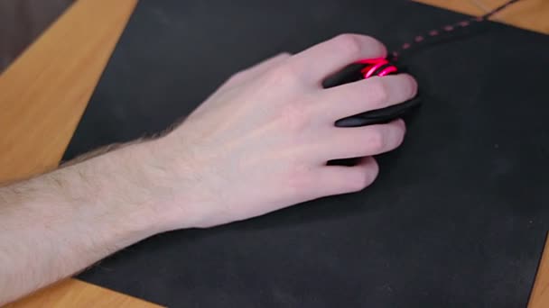 Young male gamer hand on computer mouse moving in slow motion on black mouse pad — Stock Video