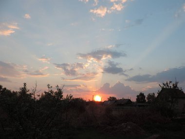Morning. Dawn over the village. Early sun.