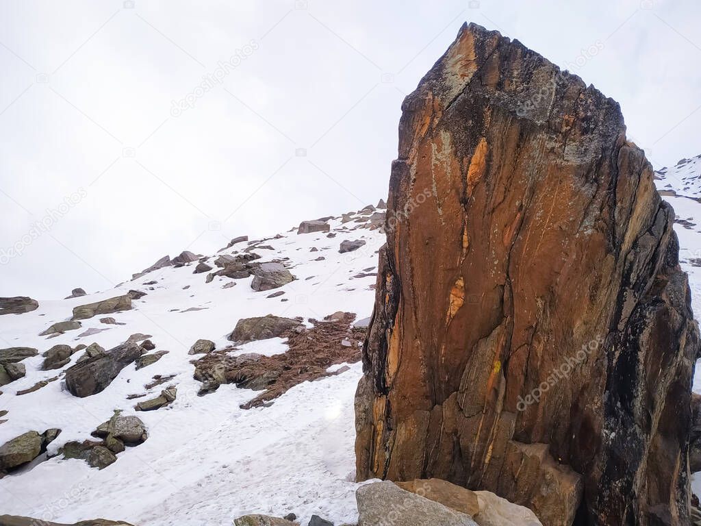 A rock right side in the snow covered mountains