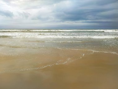 Soft ocean wave of the sea on the sand background.