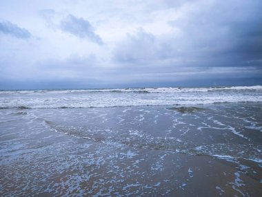 Beautiful clouds over wave on sea