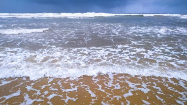 Beautiful white waves on the sea with blue sky background