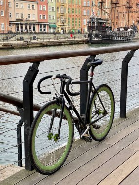 Gdansk Poland January 7, 2022. Old Town, historic buildings on the Motlawa River, the Czarna Perla ship is visible, a bicycle attached to a barge