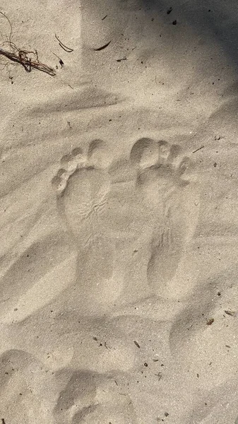 traces of man visible on sand foot left and right