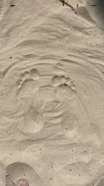 traces of man visible on sand foot left and right