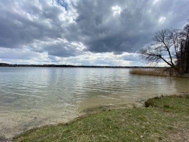 cloudy sky before sunset over lake in spring