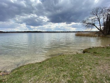 cloudy sky before sunset over lake in spring