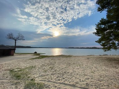 cloudy sky before sunset over lake in spring