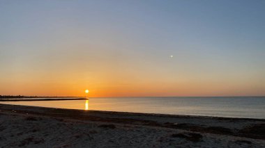 empty beaches at sunrise orange sky calm can