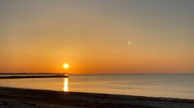 empty beaches at sunrise orange sky calm can