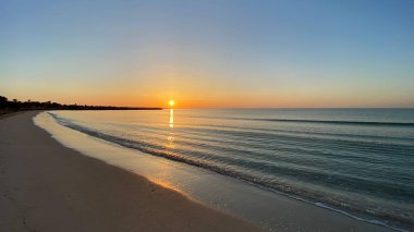 empty beaches at sunrise orange sky calm can