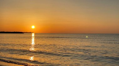 empty beaches at sunrise orange sky calm can