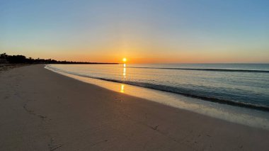 empty beaches at sunrise orange sky calm can