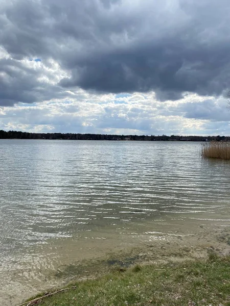 cloudy sky before sunset over lake in spring