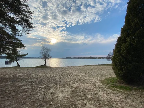 cloudy sky before sunset over lake in spring