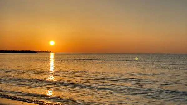 empty beaches at sunrise orange sky calm can