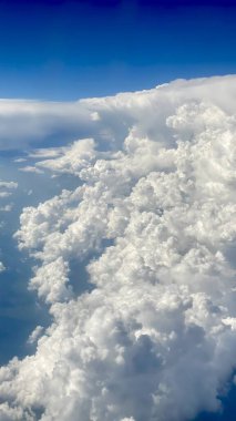 blue sky white billowing clouds arranged in various forms