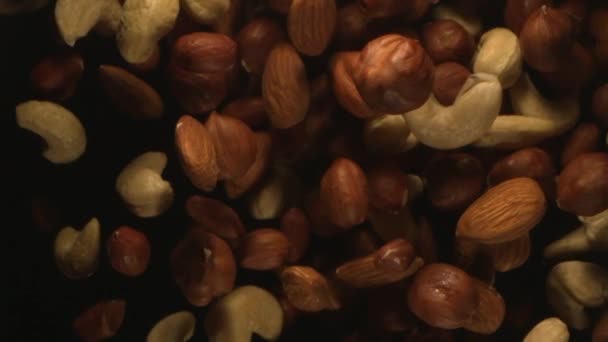 Group Nuts Falling Air High Speed Black Background Top View — Stok Video