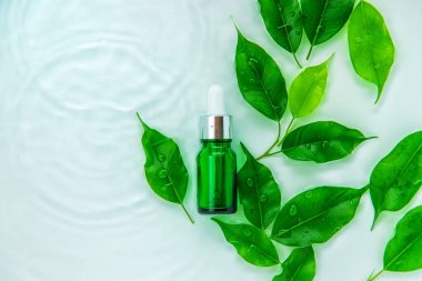 Suyun içindeki bir şişede kozmetik ürünler, cilt suyu konsepti. Seçici odaklanma. Doğa.