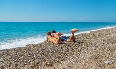 Father and daughter on the beach by the sea. Selective focus. People.