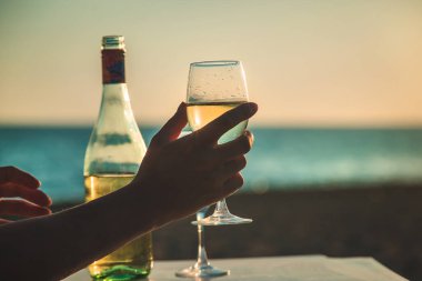 Wine glasses at sunset on the beach. Selective focus. Nature.