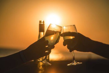 Wine glasses at sunset on the beach. Selective focus. Nature.